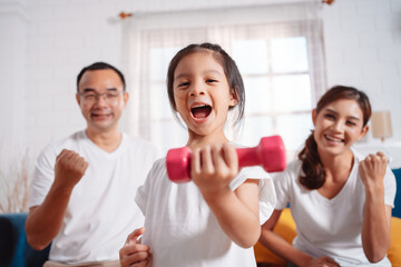 Family consisting of parents and daughters happily exercising together at home. For flexibility, build muscle strength, Sport Workout Training family together.