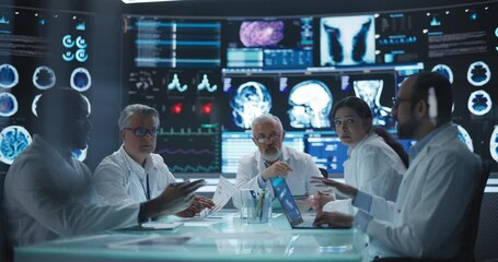 Leinwandbilder - Chief Doctor Conducting a Pre-Operative Assessment Meeting With His Surgical Team. Group of Brain Surgeons Discussing Possible Treatment in an Advanced Laboratory with Interactive Digital Screens