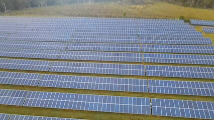 Wall Mural - aerial drone pullback reverse view of a hybrid wind and solar farm for renewable clean energy supply