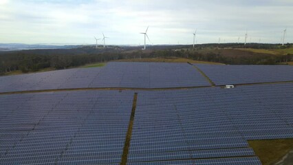 Wall Mural - aerial drone view of a hybrid wind and solar farm for renewable clean energy supply located at banni