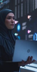 Fototapete - Vertical Screen: Arab Female Working in an Advanced Technology Company. Woman Wearing a Hijab, Using Laptop in a Room with an Artificial Intelligence Neural Network Software on a Digital Screen