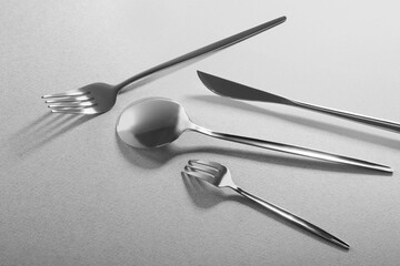 Forks, knife and spoon on grey background. Stylish cutlery set