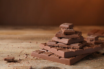 Wall Mural - pieces and crumbs of tasty chocolate bars on wooden table. space for text