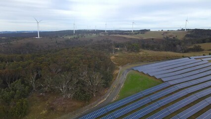 Wall Mural - aerial drone view of a hybrid wind and solar farm for renewable clean energy supply located at banni
