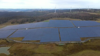 Wall Mural - aerial drone view of a hybrid wind and solar farm for renewable clean energy supply located at banni