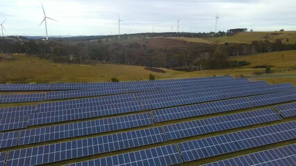 Wall Mural - aerial drone view of a hybrid wind and solar farm for renewable clean energy supply located at banni