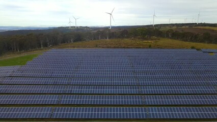 Wall Mural - aerial drone view of a hybrid wind and solar farm for renewable clean energy supply located at banni