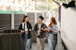 © Nuttapong punna - Three young Asian college students and a female student group work at the campus park