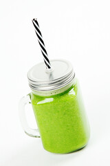 Wall Mural - Healthy green smoothie  in a jar mug  on white background