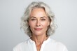 © Mustafa - Beautiful mid aged mature woman looking at camera isolated on white. Mature old lady close-up portrait. Generative AI
