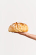 Homemade multigrain bread in woman hand over white background