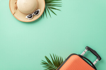 an overhead shot of an orange suitcase, beach accessories, eyewear, sunhat, and natural palm leaves 
