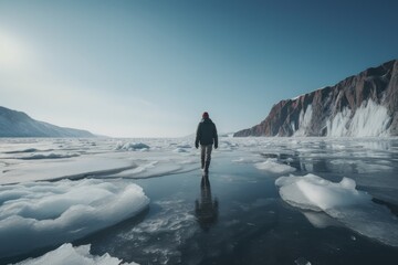 Wall Mural - a man walking across a frozen lake surrounded by mountains, generative AI