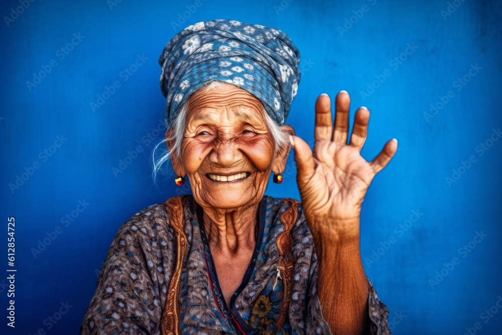 Lifestyle portrait photography of a grinning old woman making a no or ...