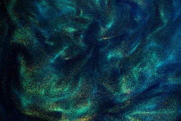 Wall Mural - various stains and overflows of gold particles in blue fluid with green tints. golden particles dust