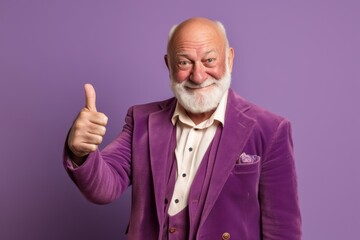 Wall Mural - Lifestyle portrait photography of a grinning old man showing a thumb down against a lilac purple background. With generative AI technology