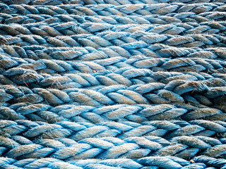 Nylon blue towing rope prepared and laying ready for towing operations on aft station of cargo vessel