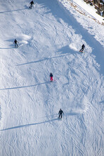 Multiple Skiers Skiing Down A Slope On Mountain Peak, Les Deux Alpes, Isère, Auvergne-Rhône-Alpes, France.