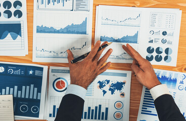 Poster - Top view analyst team discussing financial data on digital dashboard, analyzing chart and graph papers by data science software on wooden table background. Business intelligence and Fintech. Fervent
