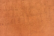 Rough textured surface of a terracotta wall. Background or backdrop. Blank for design, graphic resource