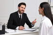 © New Africa - Human resources manager conducting job interview with applicant in office