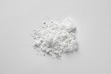 Heap of calcium carbonate powder on white background, top view