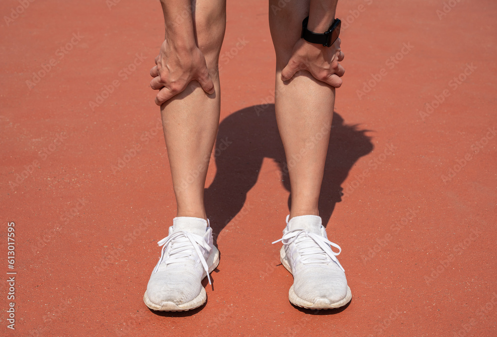 Cropped shot of female runner suffering pain from Shin splint. It often happens in the front or inside of the lower leg from overtraining. Conceptual of common running injuries.