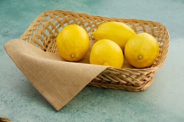 Wall Mural - Fresh yellow lemon in a basket