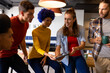 © WavebreakMediaMicro - Happy diverse male and female colleagues using tablet talking in casual meeting