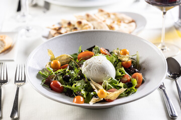 Canvas Print - Buffalo salad with greens, tomatoes, physalis, olives and the mozzarella as a centerpiece