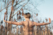 © Cavan Images - athletic muscular woman stands with arms open in natural golden reeds