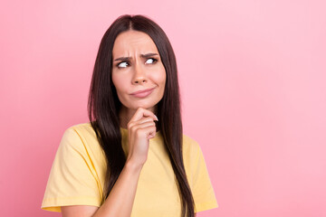 Sticker - Photo of doubtful suspicious lady wear yellow t-shirt arm chin looking empty space isolated pink color background