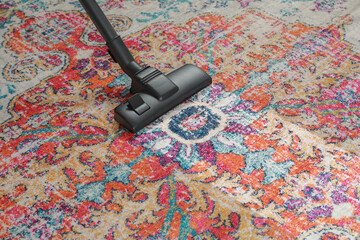 Wall Mural - Hoovering carpet with vacuum cleaner, space for text. Clean trace on dirty surface