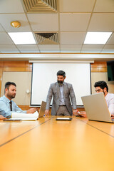 Wall Mural - Indian business coach giving training to employees group at meting hall