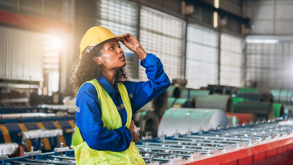 Wall Mural - Portrait of Industrial worker inspecting and check up machine at factory machines.Technician working in metal sheet at industry.