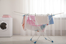 Clean Laundry Hanging On Drying Rack Indoors