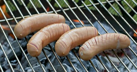 Canvas Print - sausages grilling on burning charcoal grill