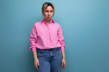 Young Touchy European Blond Office Worker Woman Dressed In A Pink Shirt And Jeans