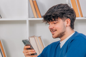 Canvas Print - young male student with mobile phone or smartphone