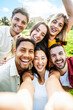 © Davide Angelini - Multiracial young people taking selfie pic with smart mobile phone device - Vertical photo of happy friends smiling at camera - Life style concept with guys and girls hanging out on summer day