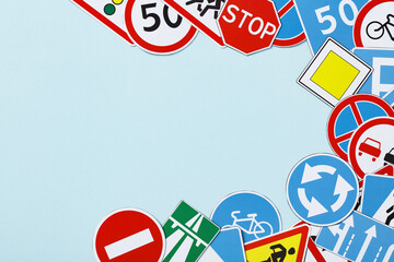 Driving school banner. Flat lay road signs and traffic symbols on color background.