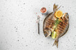 grilled whole fish dorado on a light background. Concept healthy and balanced eating. place for text, top view