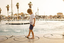 Cute Child, Boy, Playing With Water In Fountain In Tel Aviv