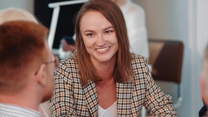 Sticker - Portrait of young happy female businesswoman talking and working together with team at table meeting in busy office