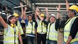 © M Stocker - Professional mechanical engineer team. Success happy workers celebrate at old motor automotive parts warehouse. Team standing hands together. Unity and teamwork concept