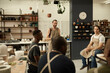 © mavoimages - Smiling workers meeting together in a ceramics studio