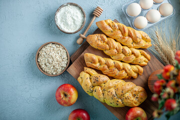 Wall Mural - top view delicious pastry with red apples and flowers on a light background dessert pie cake tea sugar fruit