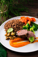 Wall Mural - Lunch beef fillet with buckwheat, broccoli, asparagus, zucchini, carrots and spinach.