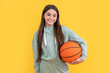 © be free - photo of glad teen basketball girl with ball. teen basketball girl isolated on yellow.