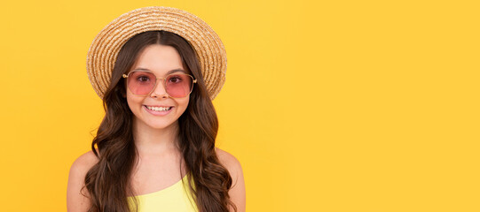 Poster - happy teen girl in summer straw hat and glasses has curly hair on yellow background, portrait. Child face, horizontal poster, teenager girl isolated portrait, banner with copy space.